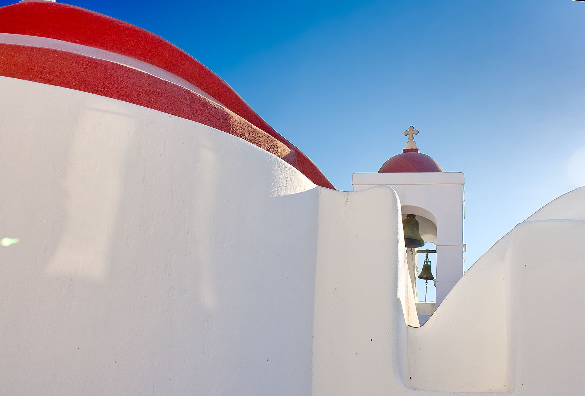 A red-domed church in Mykonos, as seen in ManAboutWorld, the gay travel magazine 