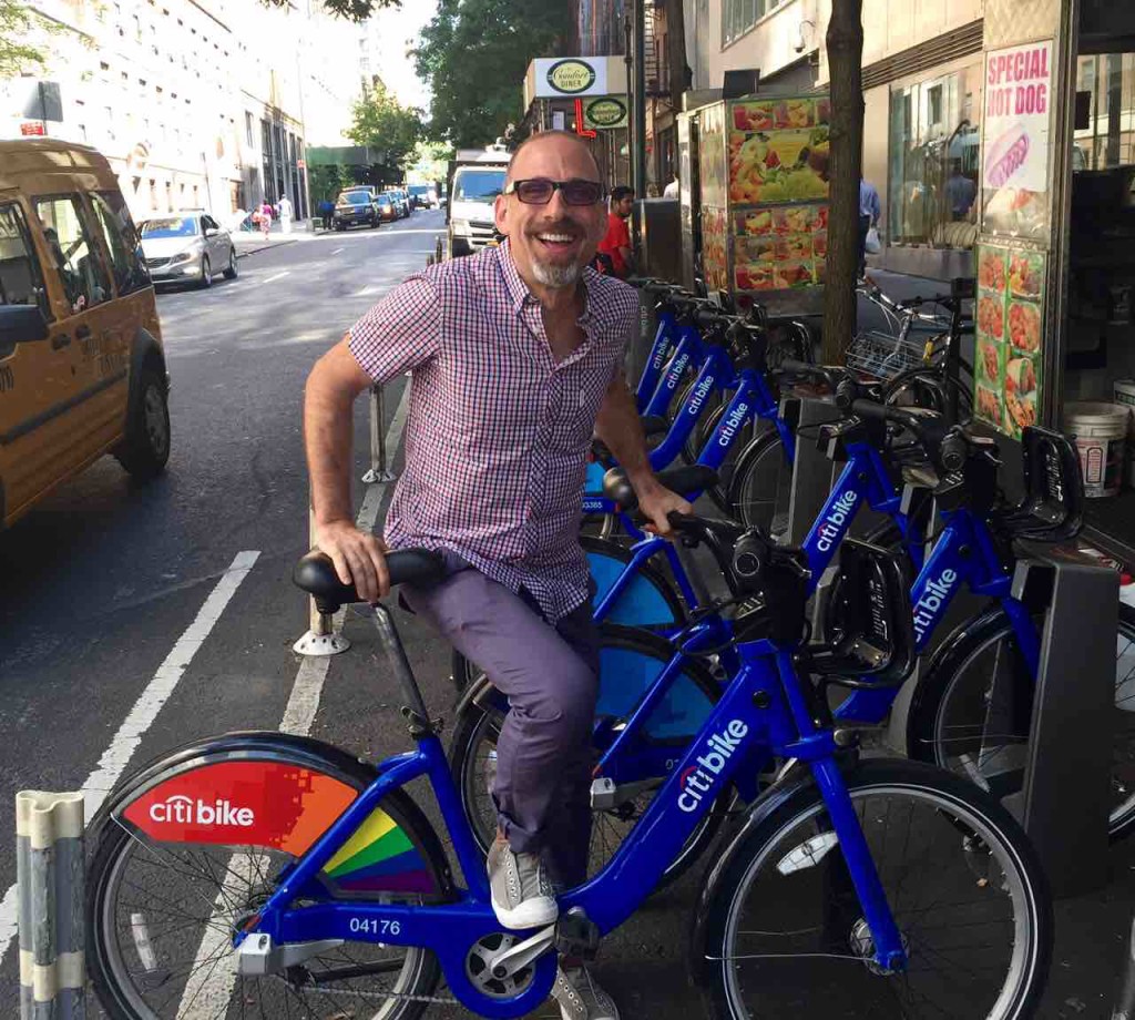 Gay pride rainbow wrapped Citi Bike in London as seen in ManAboutWorld gay travel magazine