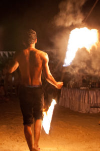 Fire juggler in ManAboutWorld gay travel magazine; meet him in Thailand using one of our Thailand gay travel experts